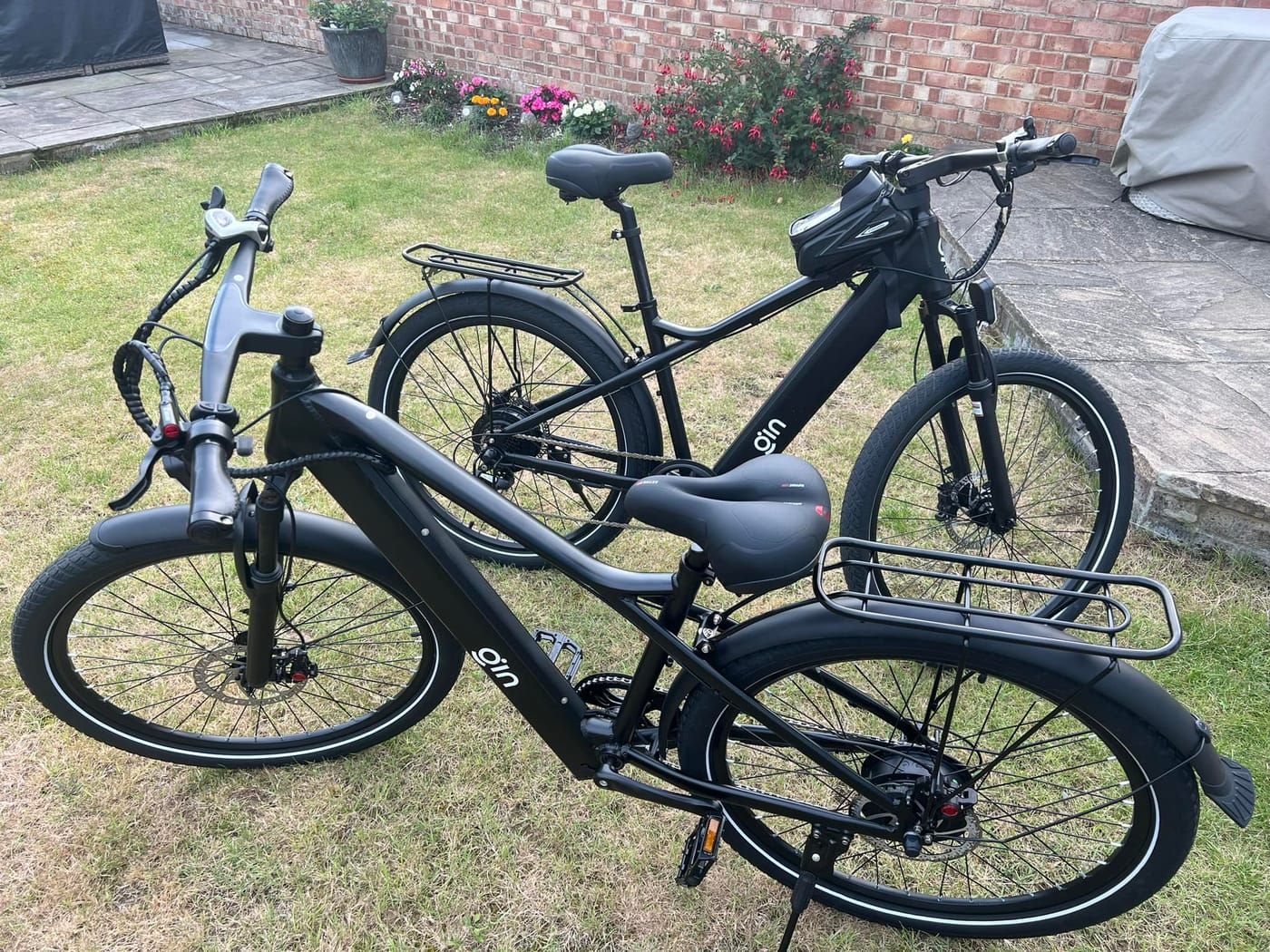 Two PLUTO e-bikes on a lawn