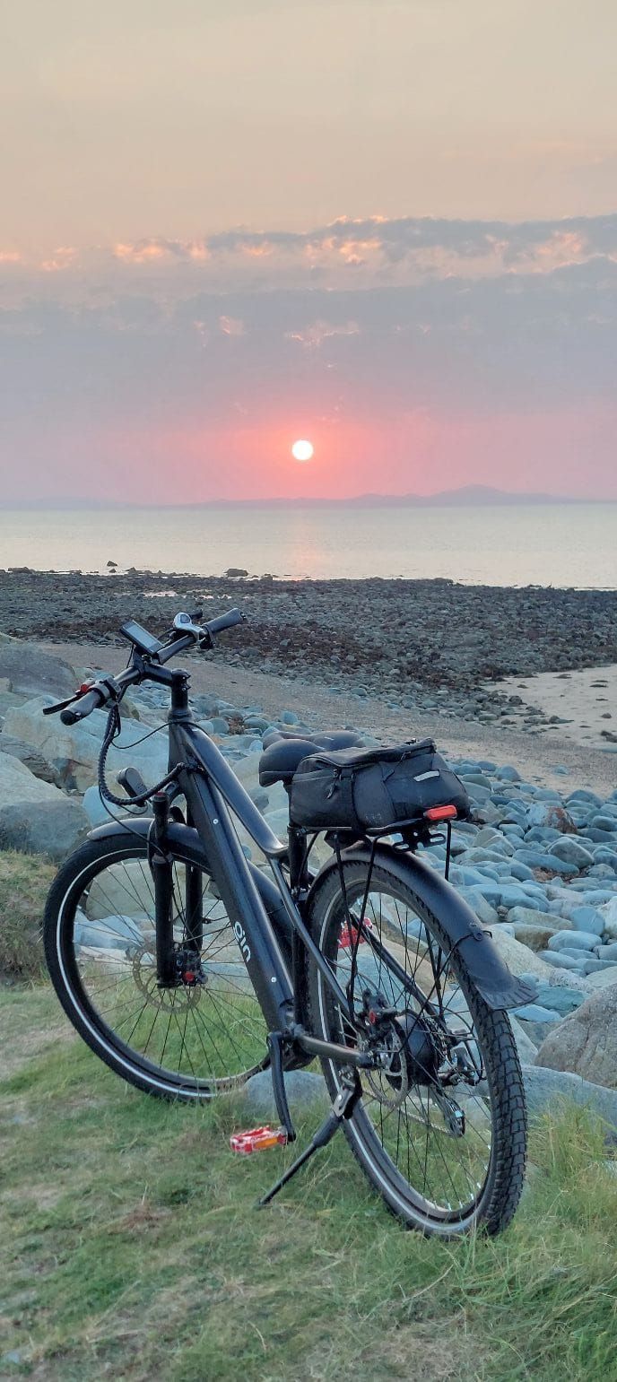 PLUTO e-bike at sunset by the sea